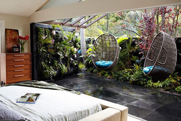 Indoor Outdoor Living bedroom styling with plants and hanging chairs